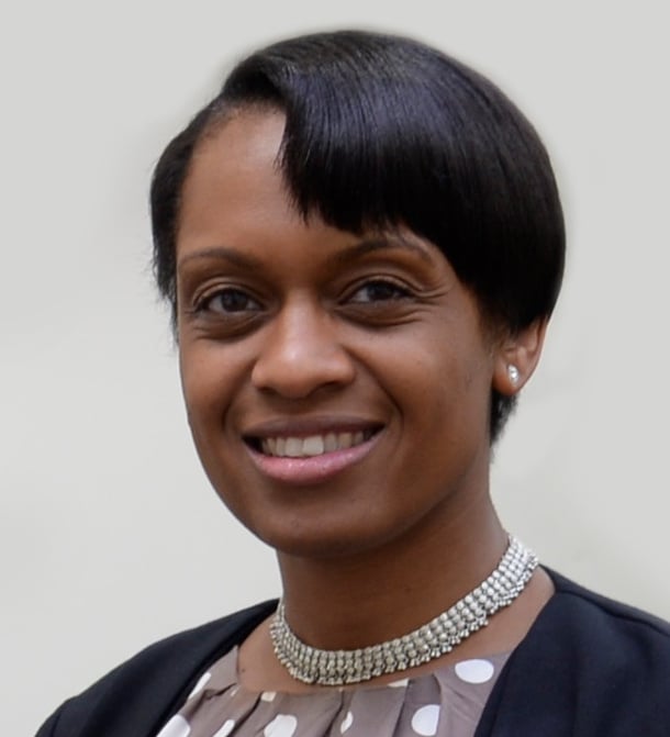 Professional headshot photograph of Dr Ruth Brown-Shepherd. A woman with medium-brown skin tone, short black hair wearing a silver necklace.